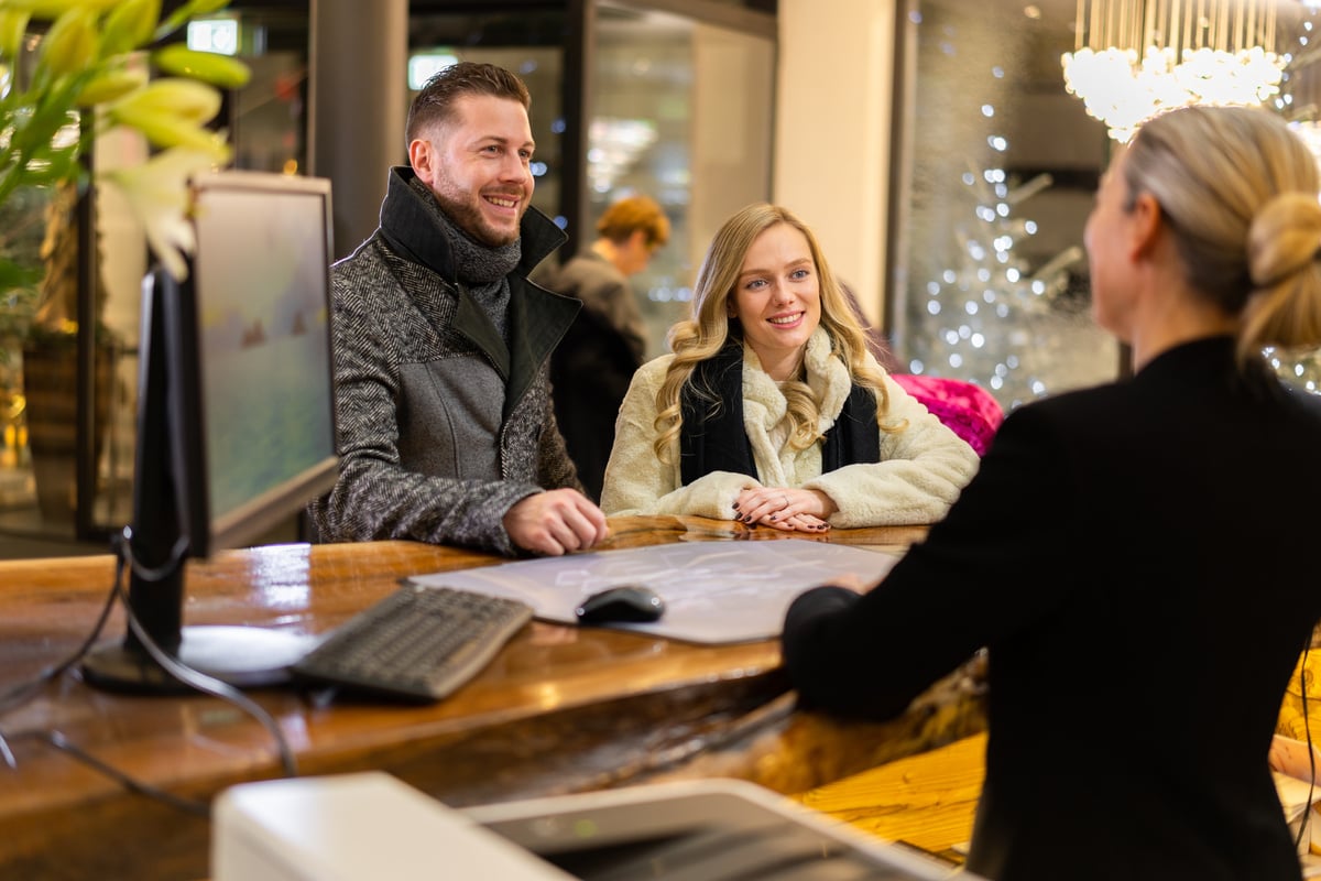 smiling wealthy guests at hotel reception